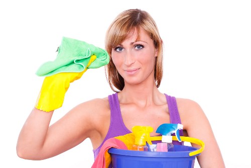 Cleaning technician preparing carpet cleaning equipment in a safe home setting
